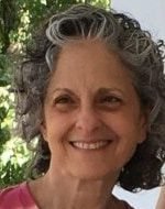 Smiling woman who uses play to help kids listen