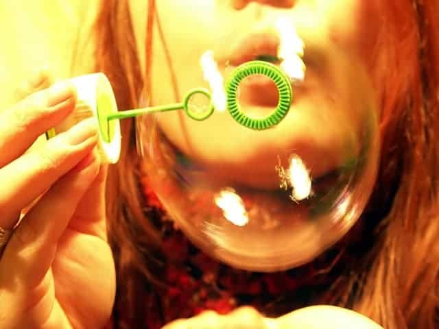 Child blowing bubbles for mindfulness meditation breathing exercise for kids